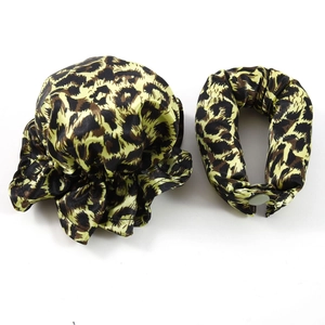 Detail of leopard print satin hair scrunchies and bun cover set with snap button