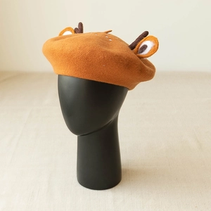Detail of cute deer antler and ear accents on a brown wool felt beret for women
