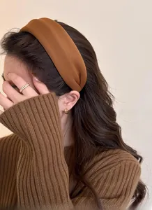Detail view of the deep brown vintage headband with matte fiber texture on model