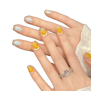 Blue and yellow handmade press-on nails with cat-eye effect and polka dot patterns