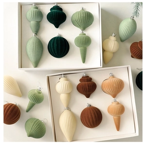 Detail of assorted velvet flocked Christmas ornaments in forest green and terracotta tones