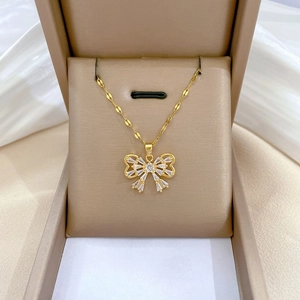 Elegant gold butterfly necklace with zircon stones in a beige jewelry gift box