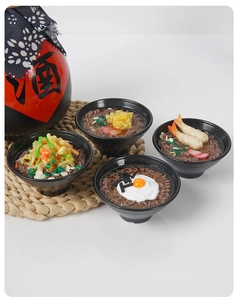 Detailed close-up of four miniature Japanese ramen bowls with shrimp and egg toppings