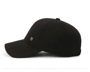Side view detail of men's winter baseball cap with plush lining and metal shield logo