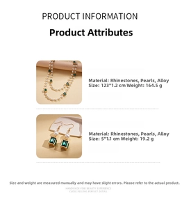 Detail of vintage layered pearl necklace and earrings set with green rhinestones