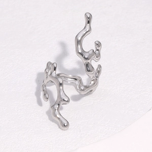 Detailed close-up of a silver irregular liquid coral style stainless steel open ring