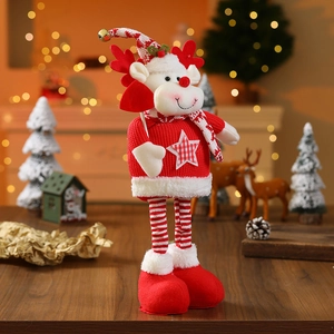 Detail of Christmas reindeer plush with red-white striped legs and star patterned sweater