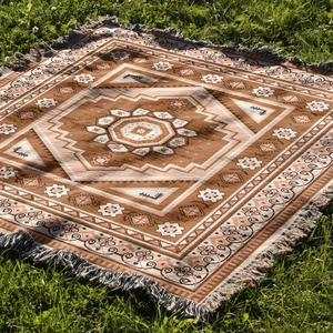 Detailed macro view of bohemian picnic blanket with fringe and geometric woven textures