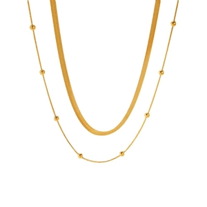 Minimalist double-layer gold snake chain and beaded necklace on a clean white background