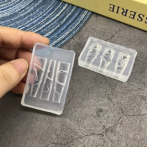 Transparent silicone nail art mold with snake pattern and three grid design on desk