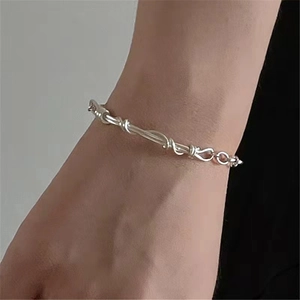 S925 sterling silver braided twist bracelet with minimalist knotted design on female wrist