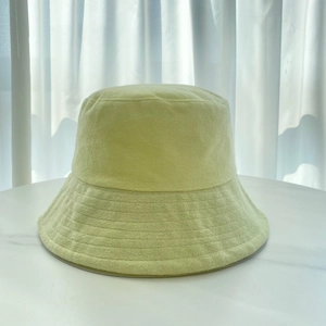 Close-up detail of soft terry cloth texture on a light yellow unisex bucket hat