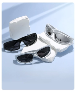 Close-up of futuristic punk sports sunglasses displayed on white stone blocks