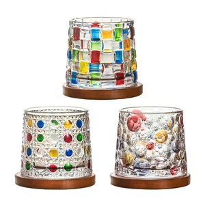 Rotating colorful crystal whiskey glasses with hand-painted patterns on wooden bases