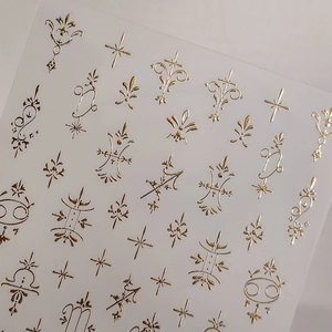 Golden vintage embossed nail art stickers with stars and floral metallic patterns