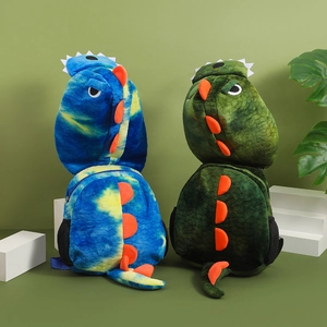 Detail of plush dinosaur backpacks in tie-dye blue and dark green with orange spikes