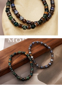 Macro shot of natural stone bracelet with moss agate and tiger eye beads for men