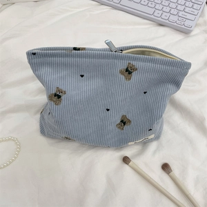 Close-up of cute bear pattern on light blue corduroy cosmetic bag with zipper