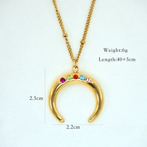 Detail of gold moon pendant with colorful zircon stones and dimension markings