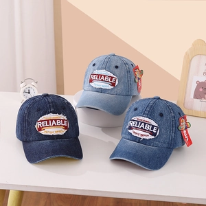 Detailed trio of vintage denim baseball caps with embroidery on a clean desk setting