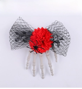 Detail of Halloween hair clip with skull hand, red rose, black spider and mesh bow