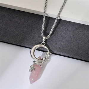Close-up of crescent moon and star pendant necklace with pink crystal and silver rope chain