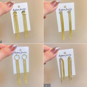 Detailed view of four elegant gold tassel drop earrings with micro-inlaid cubic zirconia