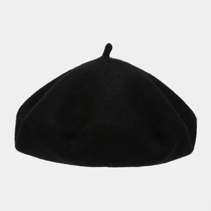Close-up of classic black wool beret showing soft felt texture and vintage round shape