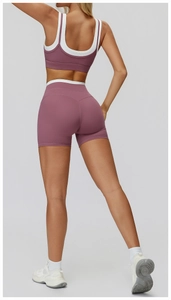 Close-up of contrast ribbed yoga set featuring mauve pink sports bra and high-waist shorts