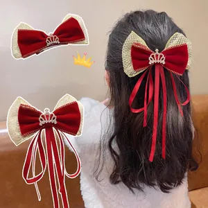 Red velvet bow hair clip with golden mesh edges and rhinestone crown pendant