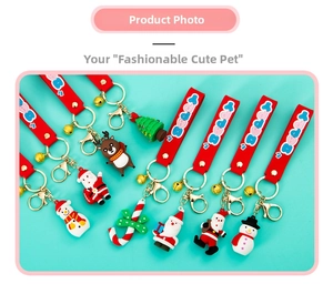 Flat lay of Christmas PVC keychains featuring Santa, reindeer, and snowman with gold clips