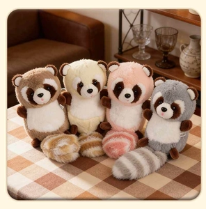 Detailed view of four colorful plush raccoon charms with fluffy striped tails and soft fur