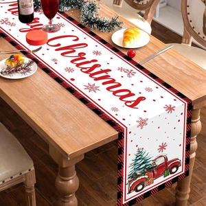 Christmas table runner with red truck and tree design on wooden dining table