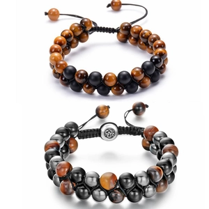 Detail of hand-woven beaded bracelet with tiger eye stones and hematite on white background