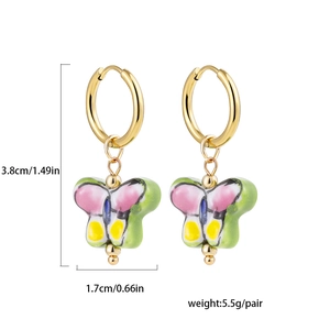 Detail view of colorful enamel butterfly earrings with size labels 3.8cm and 1.7cm