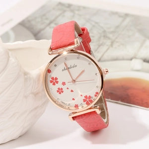 Classic vintage ladies watch with red leather strap and rose gold floral dial face
