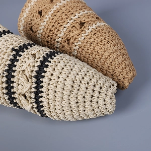 Macro detail of hand-woven straw texture with navy stripes on breathable summer sun hats