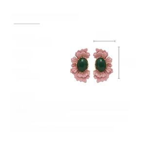 Detail of vintage flower earrings featuring pink petals and green oval glass beads