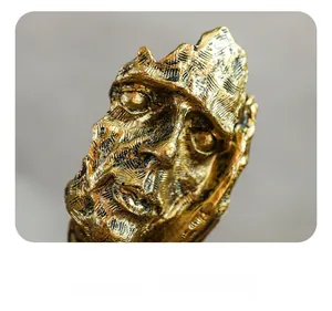 Macro detail of golden Nordic silence sculpture showing vintage textured surface and finish