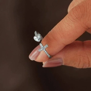Detail of adjustable heart and cross open ring with sparkling moissanite stones