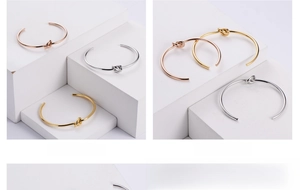 Detailed close-up of three knots minimalist stainless steel open bangles in gold, silver, rose gold