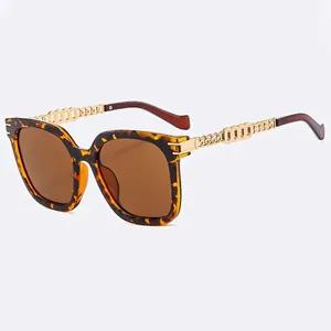 Fashionable oversized tortoise sunglasses with gold chain temples and brown lenses