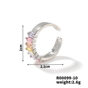 Macro shot of silver ear cuff with colorful rectangular zircons and size specifications
