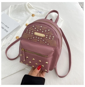Detail view of purple PU leather backpack featuring gold rivets and rhinestone accents