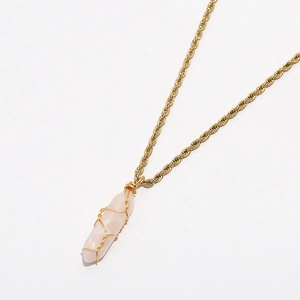 Detailed view of pink crystal pillar pendant wrapped in golden wire on a rope chain necklace