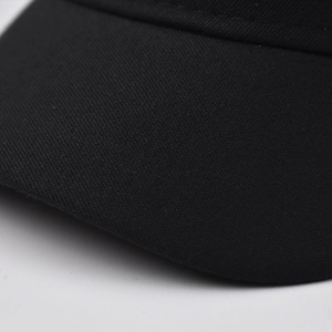 Detailed view of the black fabric texture and dense weave pattern of the military beret
