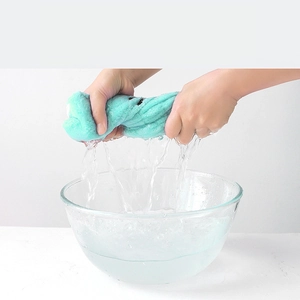 Absorbent mint green coral fleece hair towel showing high water absorption and squeeze efficiency