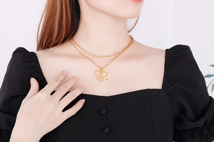 Close-up of double layer gold butterfly necklace worn by a model for daily fashion look