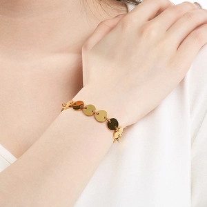 Elegant gold multi-disc bracelet for women made of minimalist stainless steel on wrist