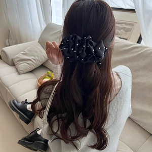 Polka dot bubble banana clip worn by a woman at home for elegant hair styling